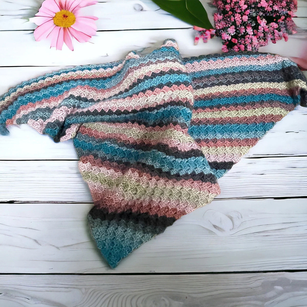 Handmade crochet scarf with multi-tonal corner pattern

Cozy winter scarf in layered crochet design

Artisan-crafted crochet scarf in boho style

Multi-color crochet scarf styled with winter coat

Handcrafted crochet wrap for women and men